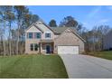 Charming two-story brick home with a well-manicured lawn and attached two-car garage at 128 Felicity Pike, Locust Grove, GA 30248