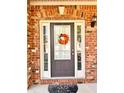 Charming front door with sidelights and a seasonal wreath for a welcoming curb appeal at 2269 Reddy Farm Ln, Grayson, GA 30017