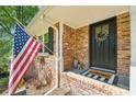 Close up of front porch with beautiful brick detail, US flag, and welcome mat at 2324 Bry Mar Ne Dr, Atlanta, GA 30345