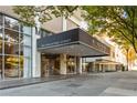 Property entrance showcasing a modern covered awning and a glass-walled lobby with comfortable seating at 620 Peachtree Ne St # 1412, Atlanta, GA 30308