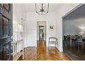 Welcoming foyer with herringbone wood flooring and a clear view of the dining room at 8925 Huntcliff Lake Ct, Atlanta, GA 30350