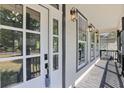 Inviting front porch with black trim, white columns, and a view of the surrounding neighborhood at 3457 Skyview Dr, Lithia Springs, GA 30122