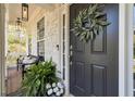 Inviting front porch with a decorative wreath on the black front door and stylish outdoor seating at 4965 Skyland Pkwy, Cumming, GA 30028
