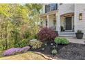 Close-up of the front yard featuring vibrant landscaping and decorative plants leading to the home's entrance at 4965 Skyland Pkwy, Cumming, GA 30028