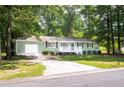 A well-maintained home featuring a spacious driveway and verdant front lawn at 879 Rock Oak Ln, Lawrenceville, GA 30046