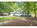 A quaint single-story house surrounded by lush greenery and a well-kept lawn at 879 Rock Oak Ln, Lawrenceville, GA 30046