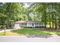 Charming ranch-style home with a well-manicured lawn, complemented by mature trees at 879 Rock Oak Ln, Lawrenceville, GA 30046