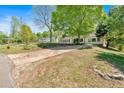 Charming ranch style home with long drive and large front yard shaded by mature trees at 144 Cathy Ln, Hiram, GA 30141