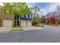 Beautiful curb appeal, featuring a two-car garage, lush green lawn, and mature trees in a peaceful neighborhood at 2700 Ridge Run Tr Trl, Duluth, GA 30097