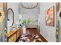 Inviting home foyer with hardwood floors, decorative lighting, and open living area at 300 Brayward Chase, Roswell, GA 30076