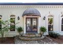 Elegant front entrance with double doors, stone steps, covered awning and decorative planters at 300 Brayward Chase, Roswell, GA 30076