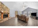 Spacious living room featuring a stone fireplace, hardwood floors, and vaulted ceiling at 6500 Chickasaw Dr, Douglasville, GA 30135