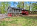 Split-level home boasts a two-car garage and a covered red front porch at 230 Oakridge Se Dr, Cartersville, GA 30121