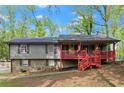 Two-story house features a stone foundation and welcoming red front porch at 230 Oakridge Se Dr, Cartersville, GA 30121