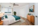 Inviting bedroom with a ceiling fan, large window and view, wood floors, and a well-organized closet space at 1501 Clairmont Rd # 1818, Decatur, GA 30033