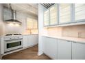 Bright kitchen with white cabinetry, stainless steel appliances, and ample counter space at 1501 Clairmont Rd # 1818, Decatur, GA 30033