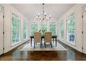Bright dining room with hardwood floors, chandelier, and large windows overlooking the backyard at 1250 Northcliff Trce, Roswell, GA 30076