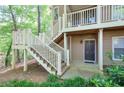 Exterior view of the entry of units 2120, 2122, and 2124, with white stairs and green foliage at 2120 River Heights Se Walk, Marietta, GA 30067