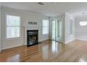 Open-concept living room boasts hardwood floors, fireplace, and sliding door access to balcony at 2120 River Heights Se Walk, Marietta, GA 30067