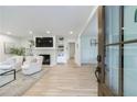 Bright living room featuring a fireplace, hardwood floors, and an open layout to other parts of the home at 2840 Alpine Rd, Atlanta, GA 30305