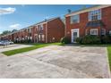 Brick townhome exteriors showcasing uniform design and easy access parking at 5679 Windfall Ln, Lithonia, GA 30058