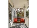 Inviting porch featuring a cozy swing with vibrant orange pillows, perfect for relaxation and enjoying the outdoors at 27 Spence Ne Ave, Atlanta, GA 30317