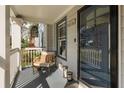 Charming front porch with seating area, elegant lanterns, and a stylish front door, enhancing curb appeal at 27 Spence Ne Ave, Atlanta, GA 30317