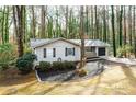 Charming single-story home with black accents, garage, and well-manicured front yard at 5000 Northland Sw Rd, Mableton, GA 30126