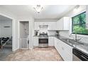 Bright kitchen with stainless steel appliances, granite countertops, and modern white cabinetry at 7060 Steel Wood Nw Dr, Kennesaw, GA 30152