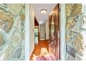 Inviting entryway with a wooden door and stone walls leading to a bright interior at 175 Flat Creek Ct, Fayetteville, GA 30214