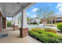 Welcoming front porch with brick accents and lush landscaping, creating a cozy outdoor space at 2238 Well Springs Dr, Buford, GA 30519