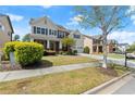 Inviting two-story home boasts a green lawn, charming landscaping, and a convenient two-car garage at 2238 Well Springs Dr, Buford, GA 30519