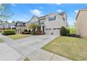 Traditional two-story home with a well-kept lawn, driveway, and an attached two-car garage at 2238 Well Springs Dr, Buford, GA 30519
