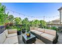 Comfortable outdoor living space with plush seating, string lights, and lush greenery at 558 Bismark Ne Rd, Atlanta, GA 30324