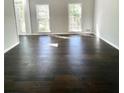 Spacious room with dark wood floors, flooded with natural light through large windows at 180 Shyrewood Dr, Lawrenceville, GA 30043