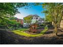 Spacious backyard with lush lawn, mature trees, and a charming playset at 2270 Abbey Cove Ct, Marietta, GA 30062