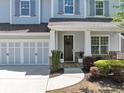 Inviting front porch and two-car garage with stone accents on this traditional-style home at 2641 Se Parks Edge Se Dr, Smyrna, GA 30080