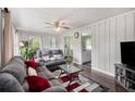 Comfortable living room featuring paneled walls, wood floors, and a ceiling fan for added comfort at 4061 Newman Ellis Rd, Douglasville, GA 30134