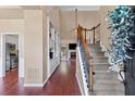 Open foyer featuring hardwood floors, staircase with iron spindles, built-in shelving, and views into the living area at 2106 Berryhill Se Cir, Smyrna, GA 30082