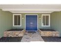 Close-up of a home's light-green exterior with a blue double-door entrance and decorative stonework at 350 Somerset Se Ln, Marietta, GA 30067