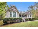 Charming home featuring a covered front porch, manicured landscaping, and brick accents at 469 Kimberly Ct, Mcdonough, GA 30252