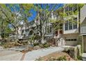Attractive townhouse featuring brick accents, modern windows, and a well-manicured front yard and convenient garage at 1294 Fernwood Ne Cir, Brookhaven, GA 30319