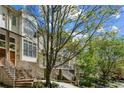 Beautiful townhouses with brick steps, modern windows, and lush greenery for a serene living environment at 1294 Fernwood Ne Cir, Brookhaven, GA 30319