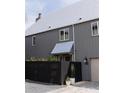 Stylish home exterior featuring gray siding, a gray roof, and manicured landscaping at 135 Channing Ln, Fayetteville, GA 30214