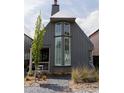 Unique home exterior with modern architecture, a charming porch, and stone landscaping at 135 Channing Ln, Fayetteville, GA 30214