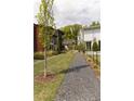 Scenic view of well-maintained lawns and gravel paths between modern homes at 135 Channing Ln, Fayetteville, GA 30214