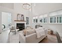 Bright and airy living room featuring a cozy fireplace, modern furniture, and ample natural light through large windows at 135 Channing Ln, Fayetteville, GA 30214