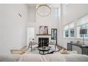 Bright, modern living room with high ceilings, fireplace, stylish furniture, and abundant natural light from large windows at 135 Channing Ln, Fayetteville, GA 30214