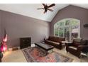 Cozy living room with vaulted ceilings, large windows, and comfortable seating at 220 Autumn Sage Dr, Alpharetta, GA 30005