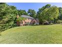 Well-maintained brick house on a large, grassy lot with mature trees at 3051 Deanna Way, Lawrenceville, GA 30044